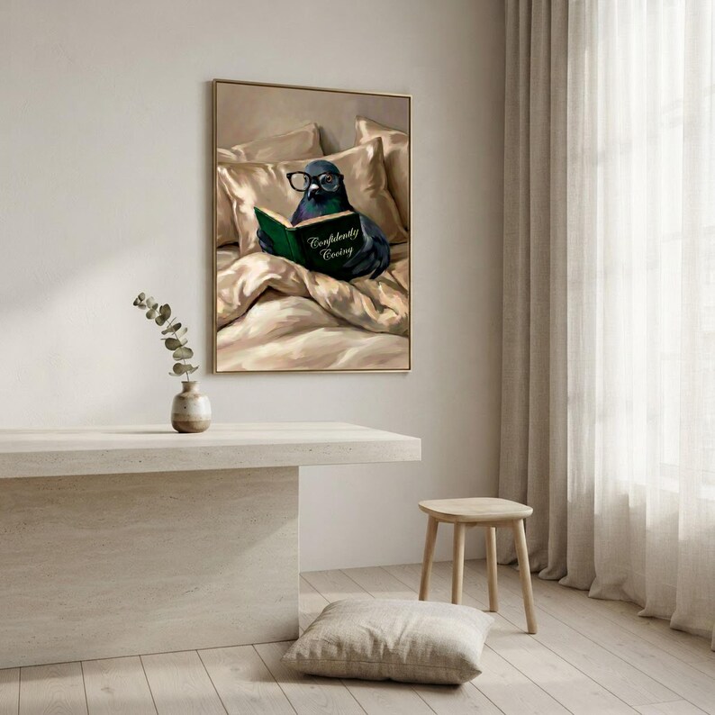 The framed pigeon print on a pale wall above a plaster bench, with a wooden stool, a floor cushion and a sheer curtain in soft daylight
