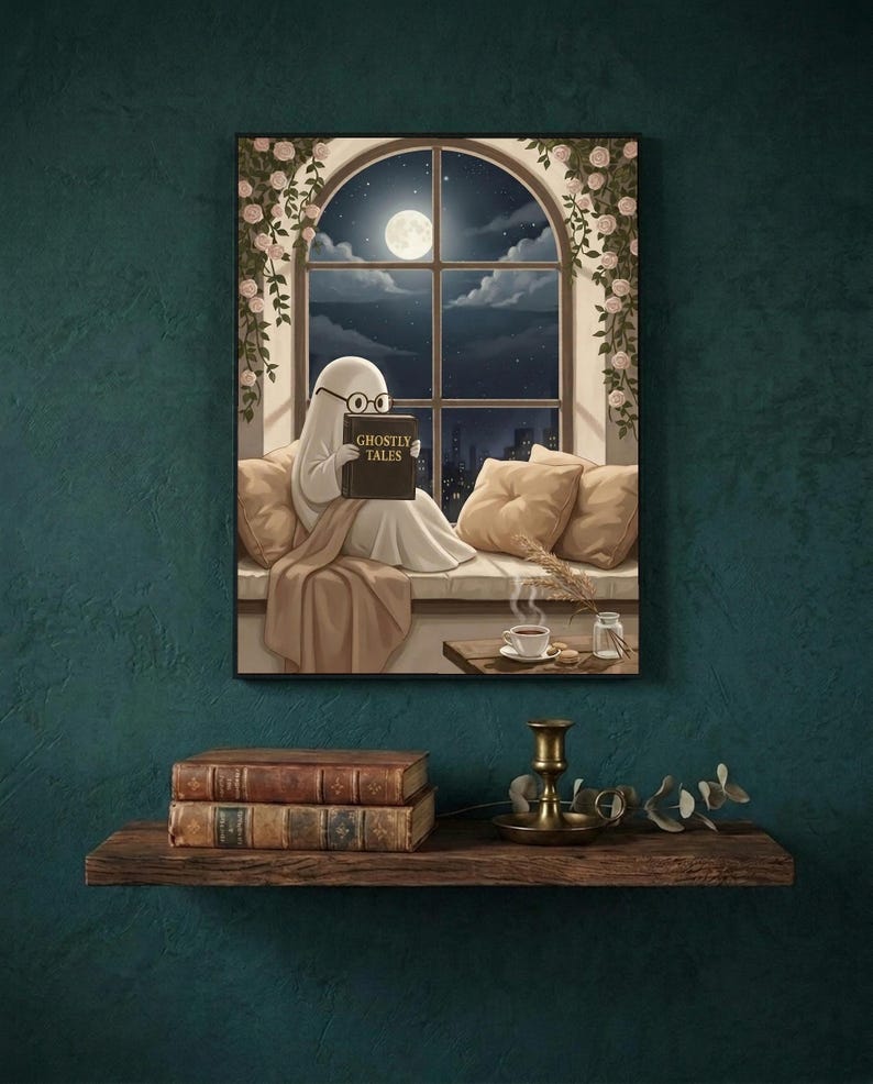 The window seat coffee ghost reading print framed on a deep teal wall above a narrow shelf with antique books and a brass candlestick