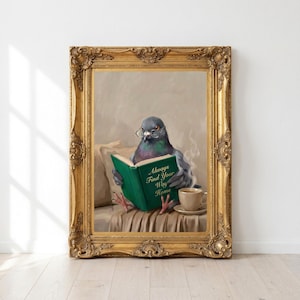 Printable pigeon reading print in an ornate antique gold frame leaning against a white wall on a pale oak floor in morning sunlight