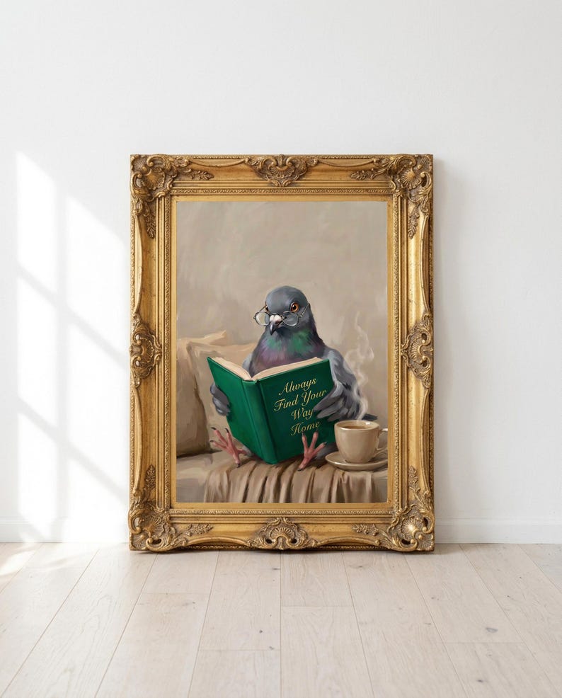 Printable pigeon reading print in an ornate antique gold frame leaning against a white wall on a pale oak floor in morning sunlight