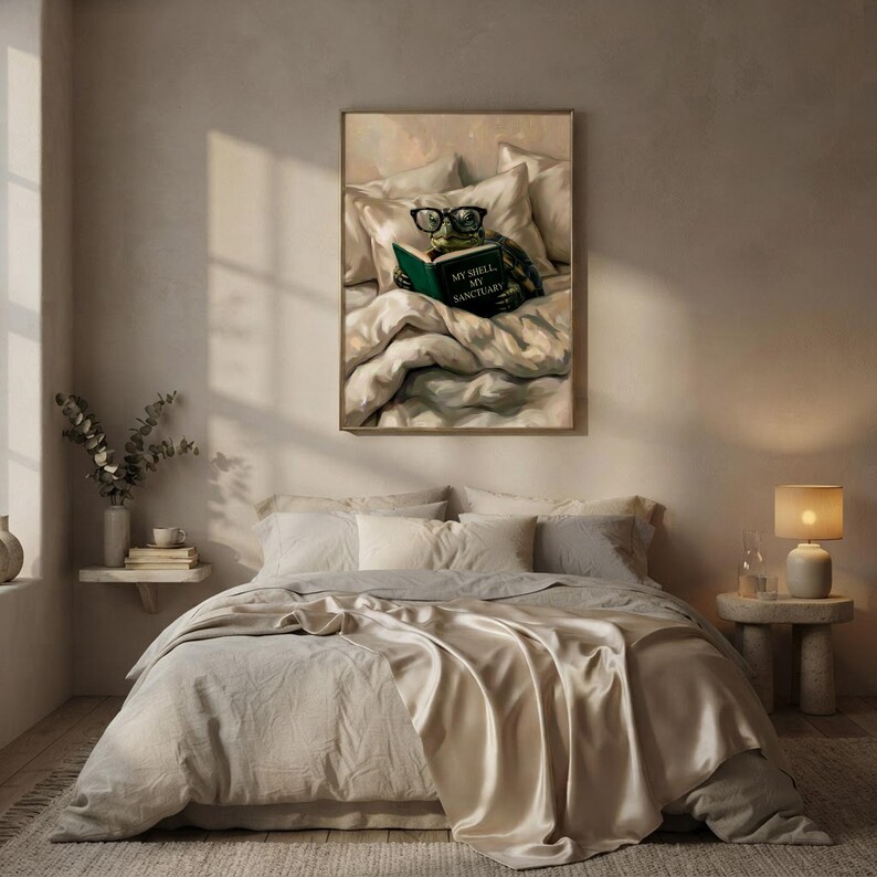 The framed tortoise print above a bed with layered linen bedding, a small lamp and a stem of dried branches on a shelf