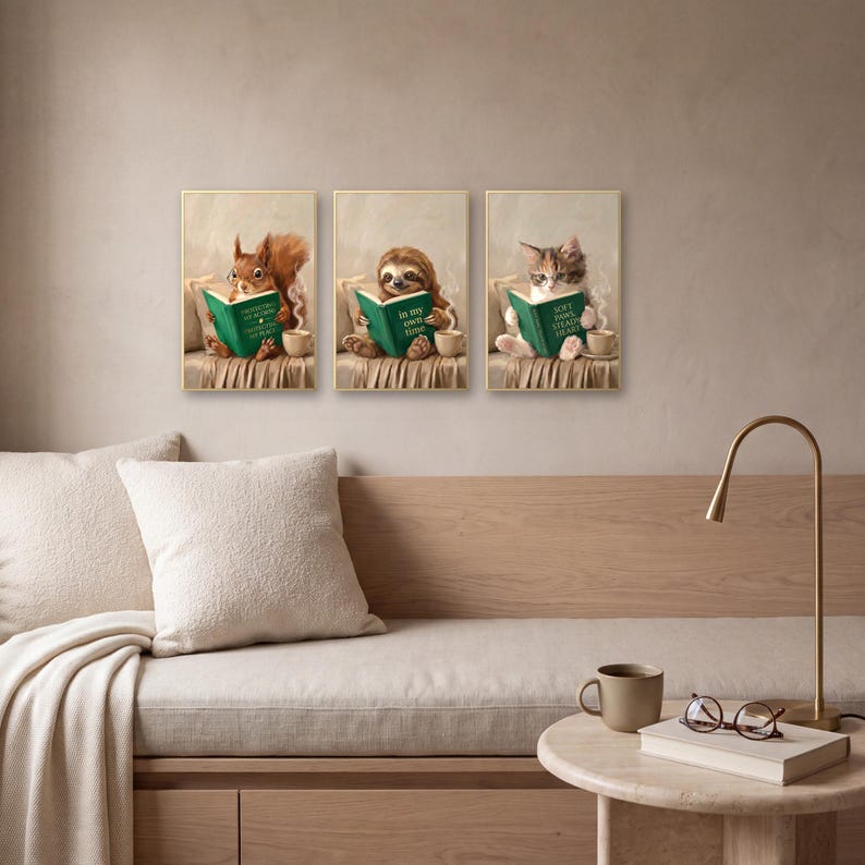 Three prints from the set, the squirrel, the sloth and the kitten, above a wooden daybed with a bouclé cushion, a brass arc lamp and a small travertine side table