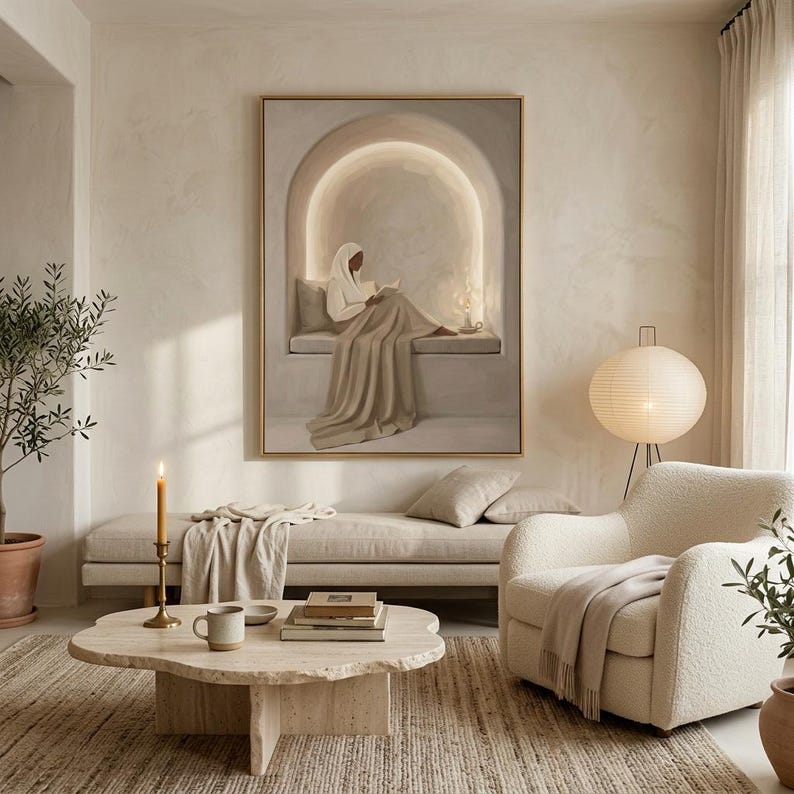 May include: A large rectangular wall art print featuring a person in a white head covering and beige clothing sitting in a recessed arched alcove while reading a book. The artwork uses a neutral color palette of cream, beige, and soft white tones.