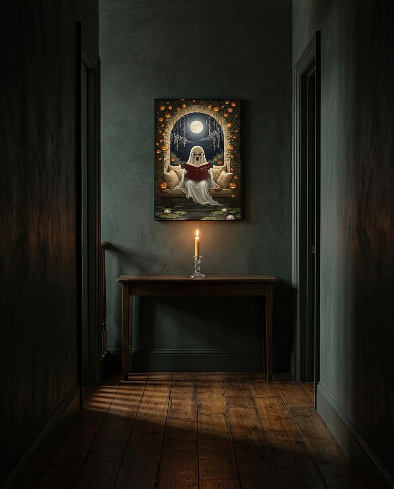 The pumpkin arch ghost reading print framed alone in a dim charcoal-green hallway above a console with a single lit candle