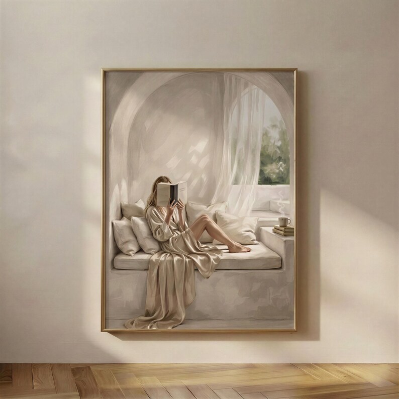 Reading Nook 4 print in a gold frame: a woman in a satin robe reclining on a cushioned window seat behind a sheer curtain, an open book resting over her face.