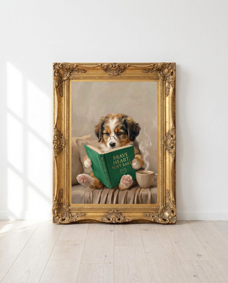Printable puppy reading print in an ornate antique gold frame leaning against a white wall on a pale oak floor in morning sunlight