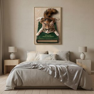 Calico kitten wall art framed on a textured plaster bedroom wall above linen bedding in soft morning light