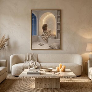 Wide living room view showing the woman reading nook wall art centered above a low sofa, gold frame, no mat.