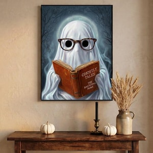The moonlit ghost reading print framed above an entryway console styled for autumn with white pumpkins and dried wheat