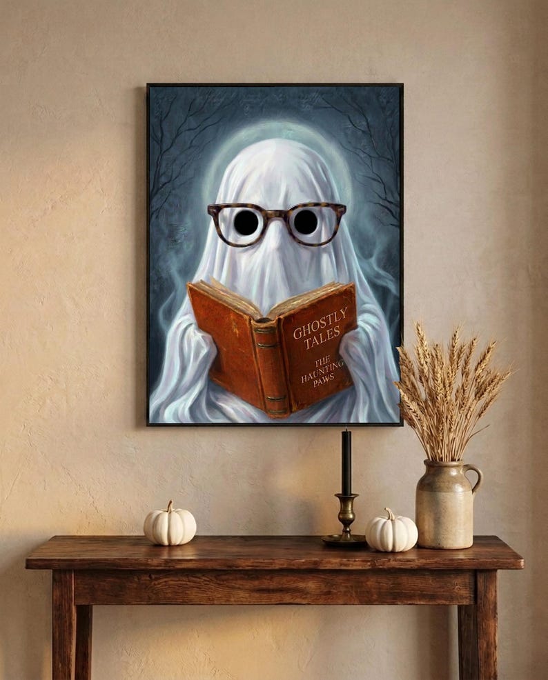 The moonlit ghost reading print framed above an entryway console styled for autumn with white pumpkins and dried wheat