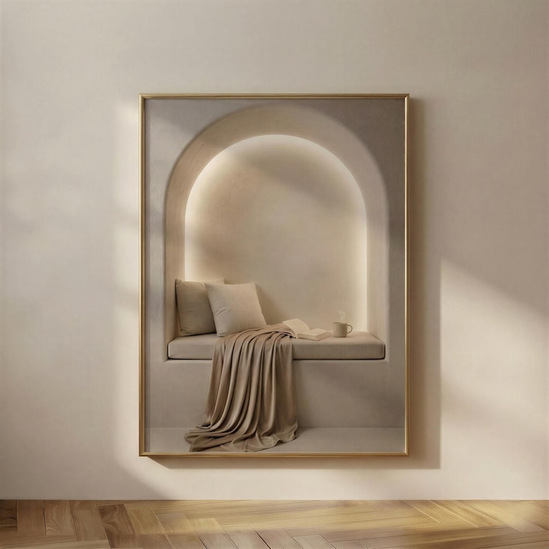 Quiet Corner print in a gold frame: an empty cushioned bench in a softly lit plaster arch with a satin throw pooling to the floor, an open book and a mug.