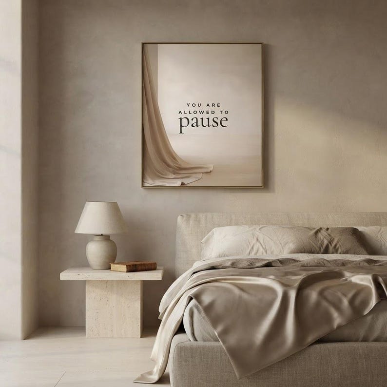 You Are Allowed to Pause styled in a quiet neutral bedroom, hung in a thin gold frame with no mat. neutral printable wall art, minimalist home decor, Japandi style, calm living room decor, slow living digital download.