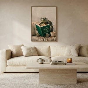 Wide view of a neutral living room with the tortoise reading print framed above a low sofa in soft daylight