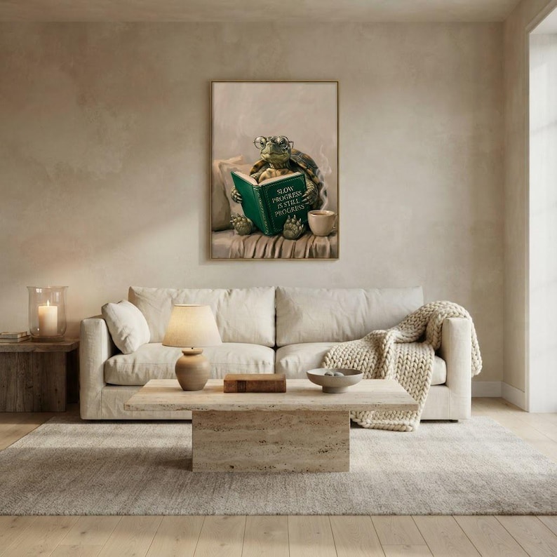 Turtle reading wall art framed on a warm plaster wall in a calm light-filled living room with a cream linen sofa