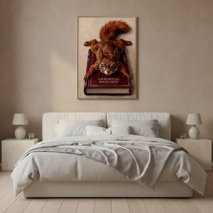 Red squirrel splooting on a book art print framed on a textured plaster bedroom wall above linen bedding in soft morning light