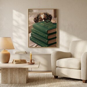 Wide view of a neutral living room with the dog peeking over books print framed above a low sofa in soft daylight