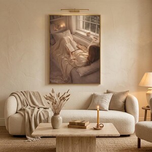 Beige wall art print framed above a cream boucle sofa in a warm minimalist living room with jute rug, dried pampas grass, and linen curtains.