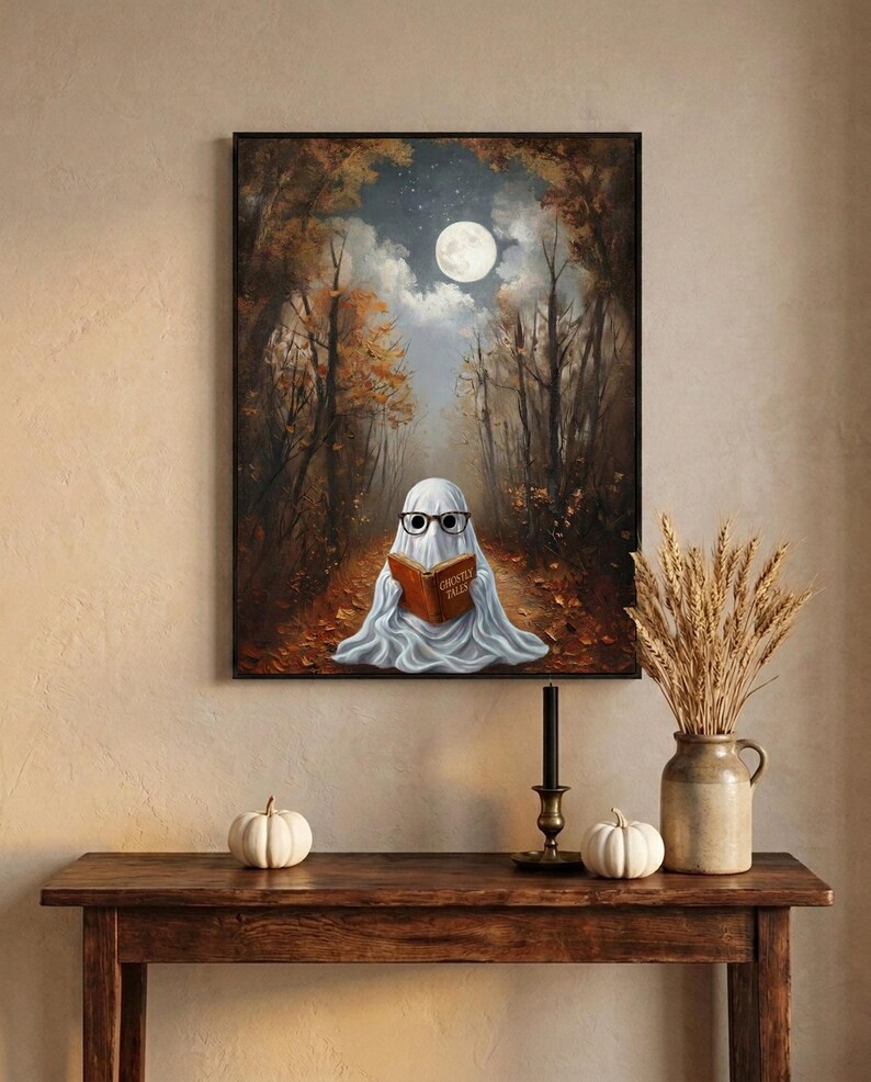 The autumn forest ghost reading print framed above an entryway console styled for autumn with white pumpkins and dried wheat