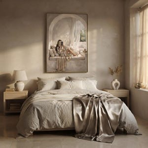Wide living room view showing the woman reading nook wall art centered above a low sofa, gold frame, no mat.