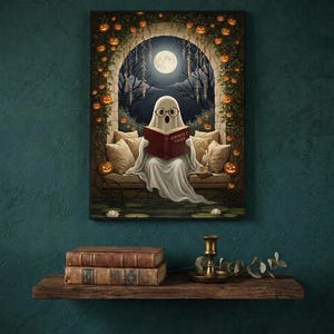 The pumpkin arch ghost reading print framed on a deep teal wall above a narrow shelf with antique books and a brass candlestick