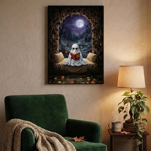 The graveyard arch ghost reading print framed above a green velvet armchair with a knit throw and a warm lamp