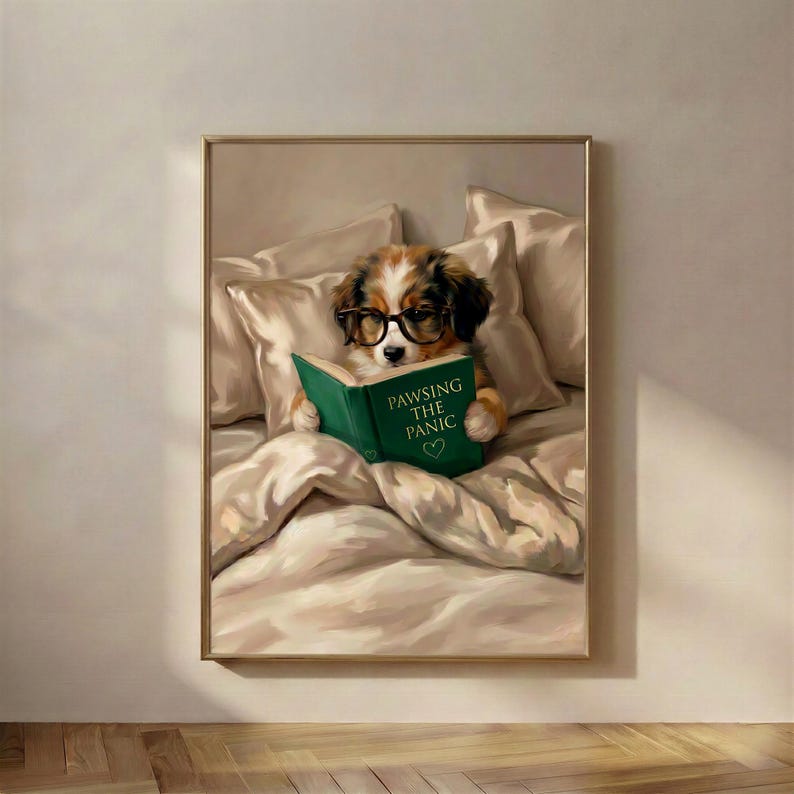 The framed dog reading print in a thin gold frame on a warm plaster wall above a wooden floor