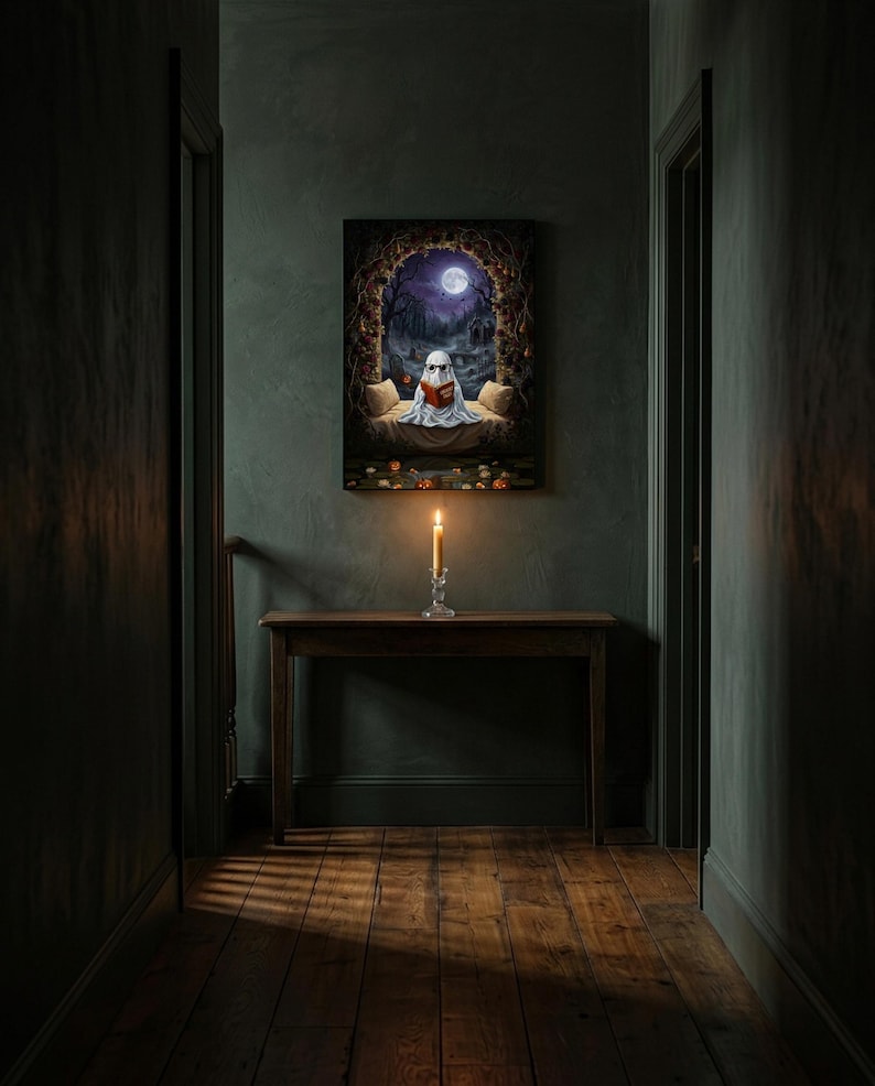 The graveyard arch ghost reading print framed alone in a dim charcoal-green hallway above a console with a single lit candle