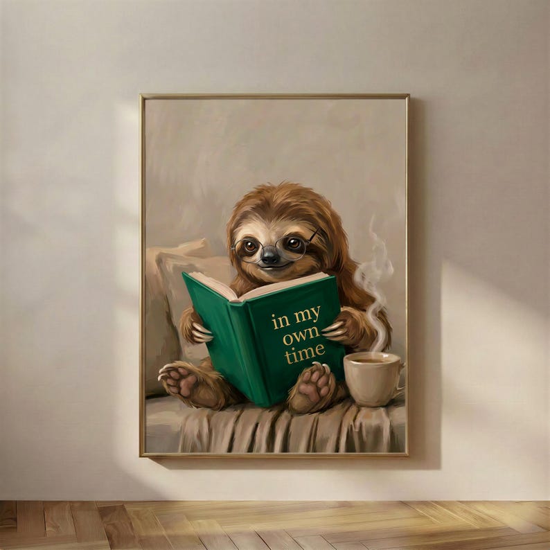 Painterly print of a sloth in round glasses reading a green book titled In My Own Time, framed on a warm plaster wall
