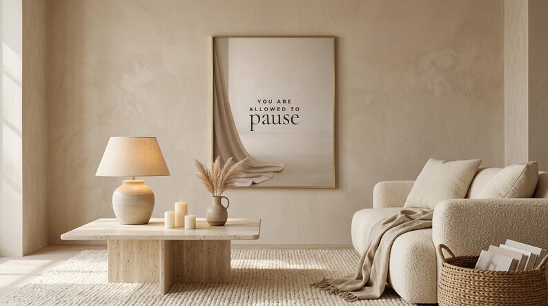 You Are Allowed to Pause styled in a wide calm neutral living room view, hung in a thin gold frame with no mat. neutral printable wall art, minimalist home decor, Japandi style, calm living room decor, slow living digital download.