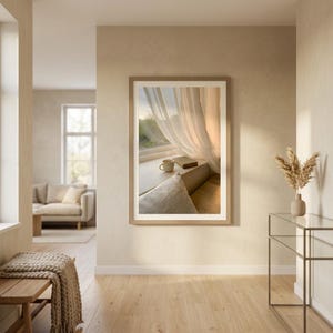 Window seat wall art print mockup with book and coffee on sunlit ledge, sheer beige curtains, Japandi slow living decor, neutral home interior, digital printable, minimalist Scandinavian design, cozy reading nook