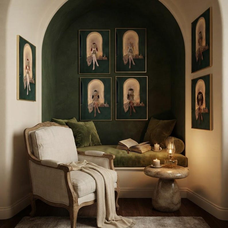 Seven emerald green reading nook art prints around a deep green arched alcove, four inside it and three on the cream wall either side, above an olive velvet daybed with an oil lamp, a lit candle and an open book.