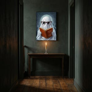 The ghost reading print hanging alone in a dim charcoal-green hallway above a console with a single lit candle