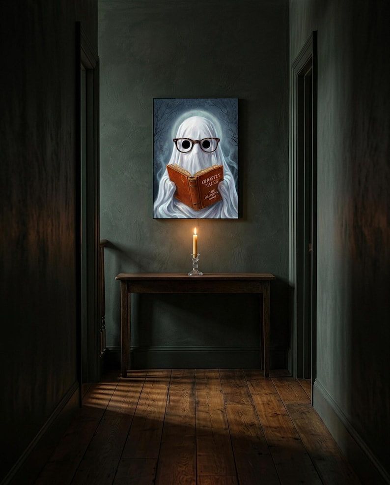 The ghost reading print hanging alone in a dim charcoal-green hallway above a console with a single lit candle
