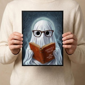 A person holding the framed ghost reading print, showing its scale against the body