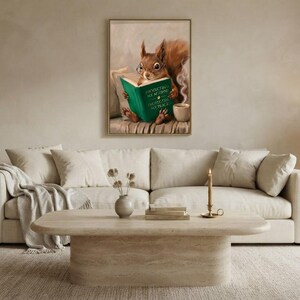 Wide view of a neutral living room with the squirrel reading print framed above a low sofa in soft daylight