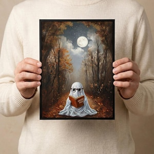 The autumn forest ghost reading print held in both hands by a person in a cream sweater, showing its scale