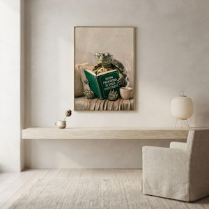 Turtle in glasses reading print framed above a restrained workspace with pale walls and a natural linen chair