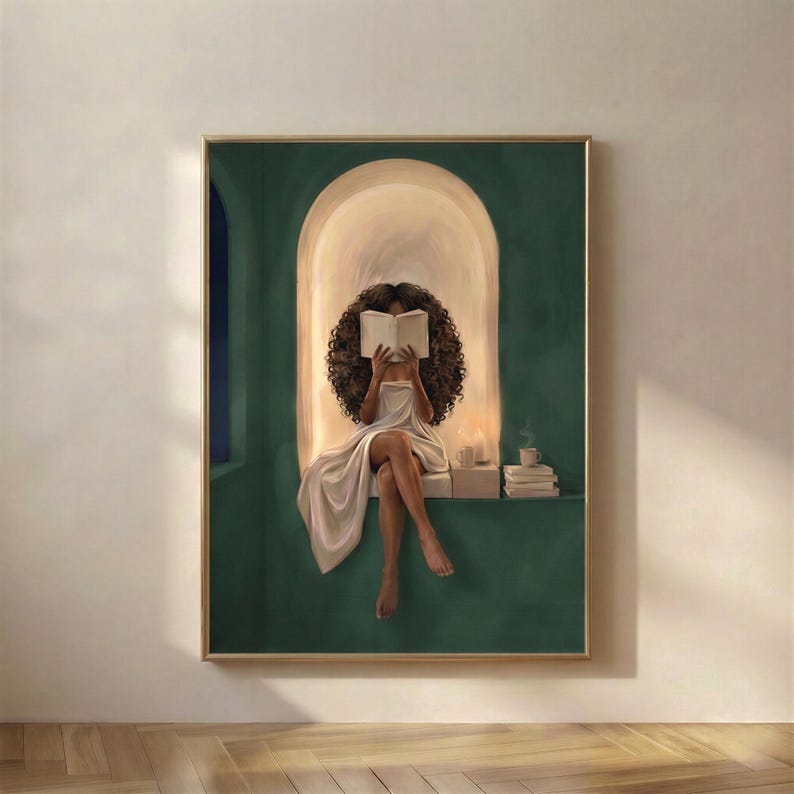 Black woman with voluminous curls reading a book in a glowing arched nook, deep emerald green walls, candle and coffee beside her, emerald green printable wall art.