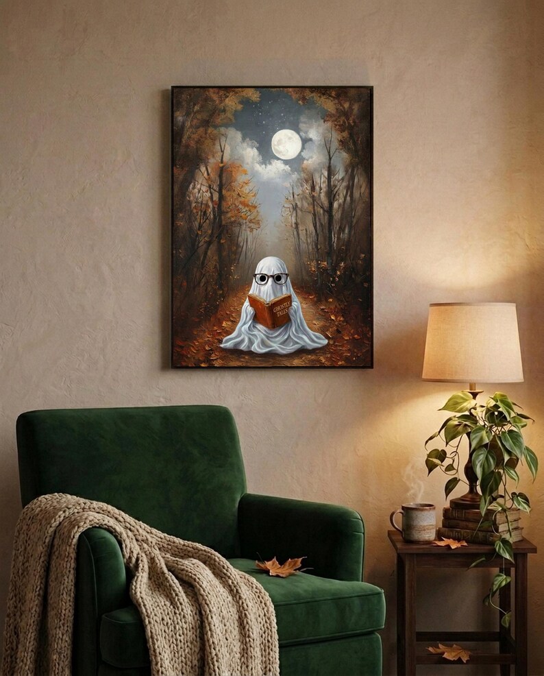 The autumn forest ghost reading print framed above a green velvet armchair with a knit throw and a warm lamp