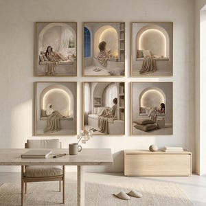 Gallery wall of six neutral reading nook prints above a travertine desk with a light oak chair, a ceramic mug and an oak credenza in a sunlit minimalist room.