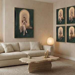 Emerald green reading nook prints in a wide plaster living room: one large print above the sofa and the full set of six framed as a grid on the adjoining wall.