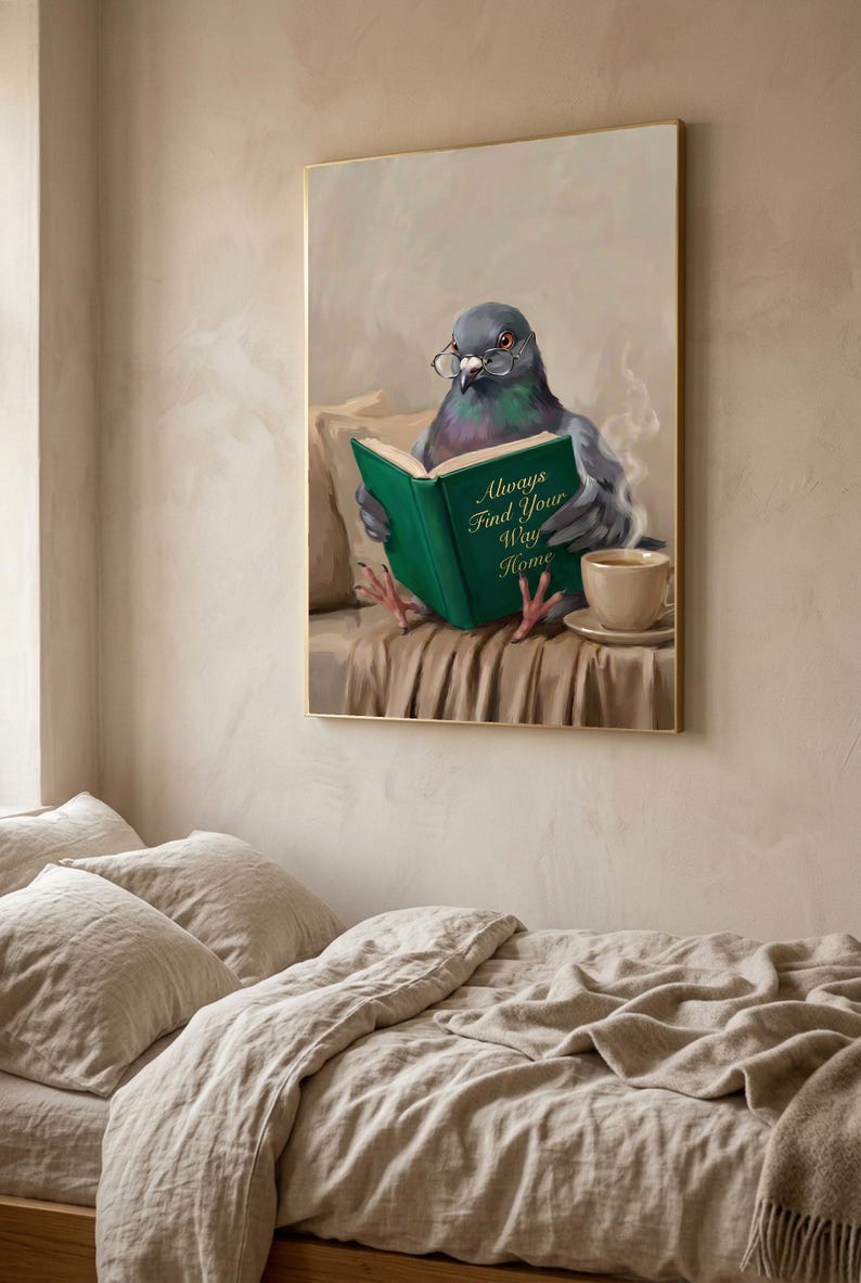 The pigeon print in a thin gold frame hanging above a bed with rumpled linen bedding