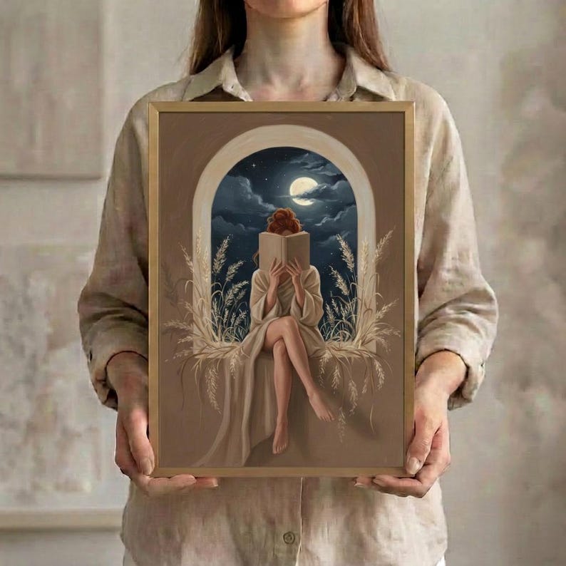 A person holding the framed moonlit reading print, showing its scale against the body