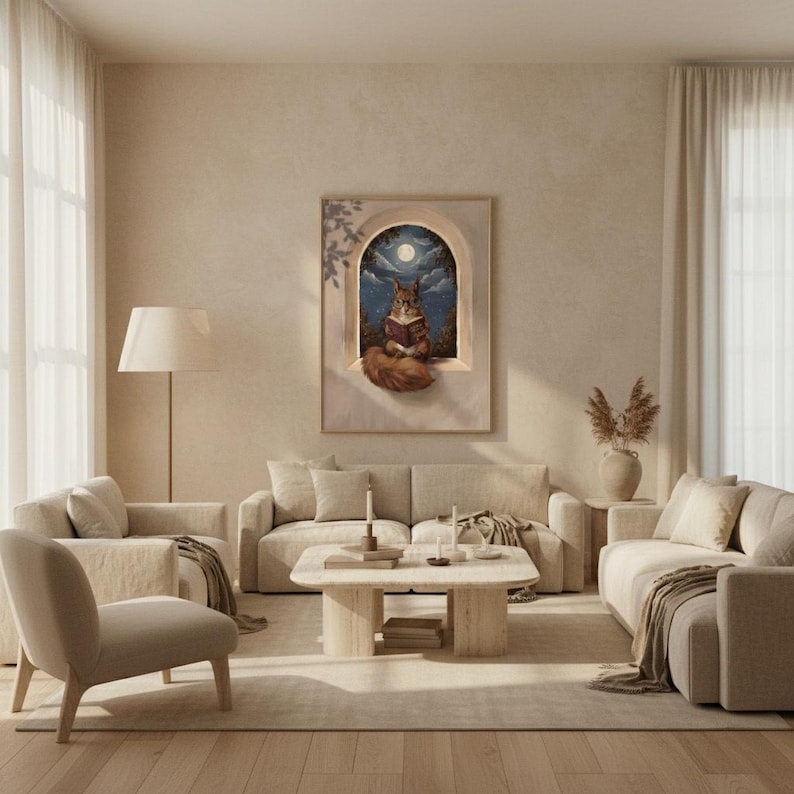 The squirrel reading print framed in a calm light-filled living room with warm plaster walls and a linen sofa
