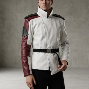 May include: White jacket with burgundy and black accents. The jacket features a high collar, black epaulets, and a black belt. The right sleeve is burgundy, and the left sleeve is white. The jacket is paired with black pants.