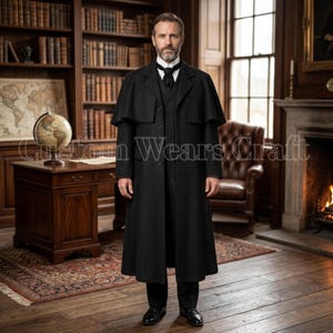May include: A black wool coat with a cape, vest, and trousers. The coat has a long, tailored design with a high collar and buttoned front. The man is wearing a black tie and black shoes. The background includes a library and a fireplace.