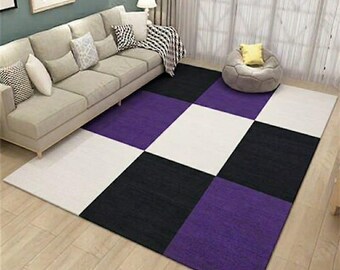 Features a high-contrast grid pattern in deep purple, charcoal black, and crisp white.