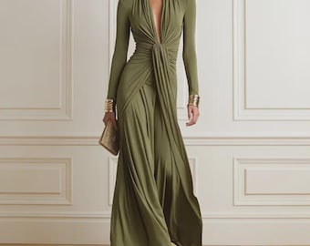 May include: A floor-length olive green long-sleeve dress featuring a deep V-neckline with a central gathered knot detail at the waist, creating a draped effect that flows into a full-length skirt. The dress is paired with gold-toned wrist cuffs.
