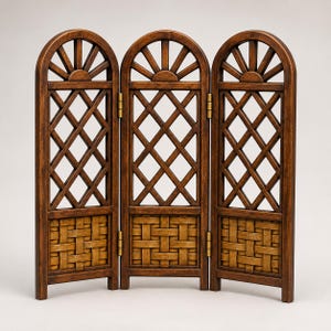 May include: A three-panel folding room divider made of dark brown wood. Each panel features an arched top with a sunburst design, a central lattice grid section, and a woven basket-weave pattern at the base, connected by brass-colored metal hinges.