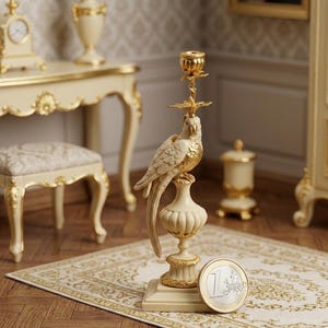 May include: A cream and gold parrot candle holder. The decorative item features a detailed bird perched on a pedestal, with a candle cup at the top. The base is square, and the design is ornate. The candle holder is likely made of ceramic or porcelain.